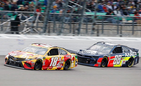 Alex Bowman (right) follows Kyle Busch during Saturday night's NASCAR Cup Series race at Kansas Speedway in Kansas City, Kan.