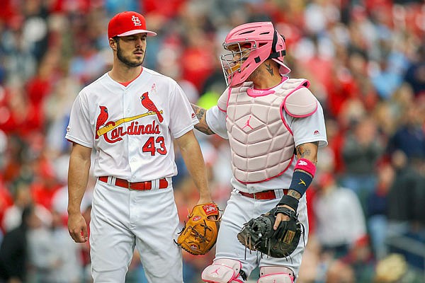 Cardinals starting pitcher Dakota Hudson talks with catcher Yadier Molina as they walk to the dugout in the middle of the fourth inning of Sunday's game against the Pirates at Busch Stadium.