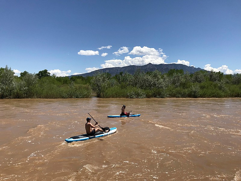In this May 4, 2019, photo two kayakers float the Rio Grande through Corrales, New Mexico. Rafting and angler guides are predicting a good season for tourism along the river thanks to strong runoff generated by a healthy snowmelt this year. (AP Photo/Susan Montoya Bryan)