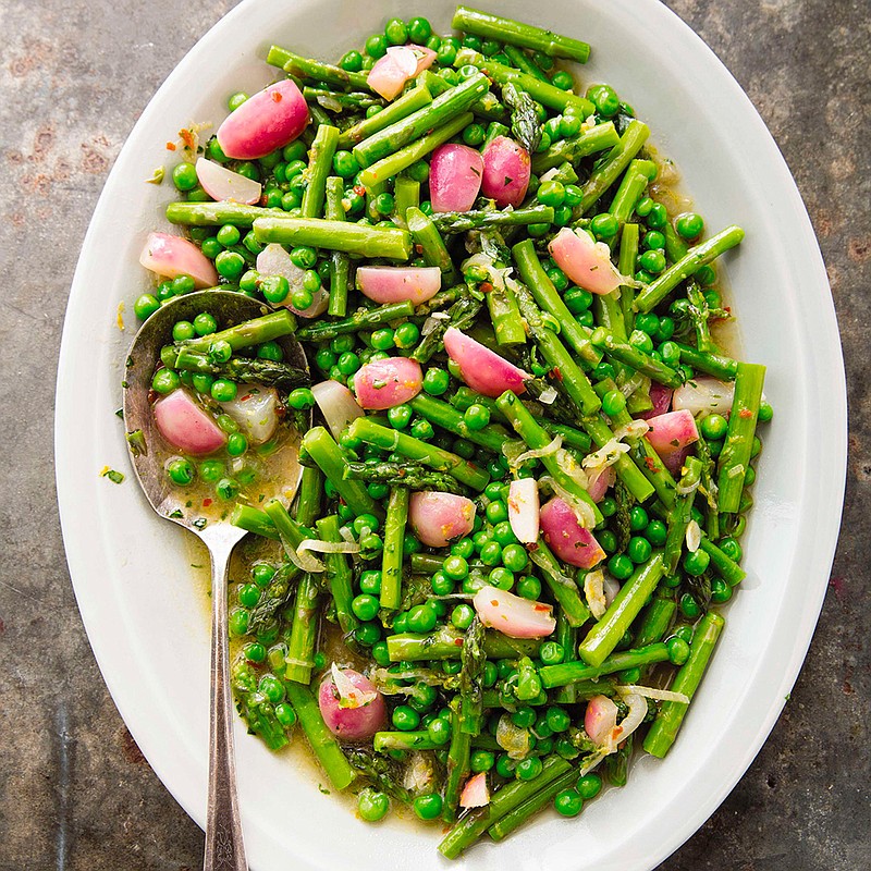 This undated photo provided by America's Test Kitchen in April 2019 shows Braised Spring Vegetables with Tarragon in Brookline, Mass. This recipe appears in the cookbook "How to Braise Everything." (Joe Keller/America's Test Kitchen via AP)