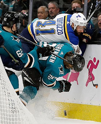 Robert Bortuzzo of the Blues fights for the puck with Sharks' teammates Kevin Labanc (left) and Marcus Sorensen during Monday night's Game 2 of the Western Conference finals in San Jose, Calif.