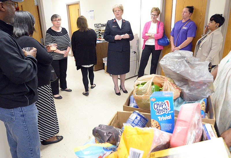 Salvation Army's Major Nancy Holloway gives a tour of the facility, which serves as a shelter, kitchen and pantry, during the Salvation Army Center of Hope Shelter & Social Services 20th anniversary celebration Tuesday.