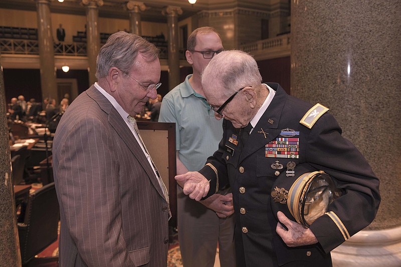 State Rep. Dave Griffith, R-Jefferson City, presents Army Col. Lloyd Cain with a challenge coin.