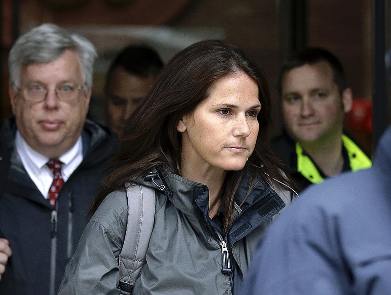 Former University of Southern California soccer coach Laura Janke departs federal court, Tuesday, May 14, 2019, in Boston, where she pleaded guilty to charges in a nationwide college admissions bribery scandal. (AP Photo/Steven Senne)