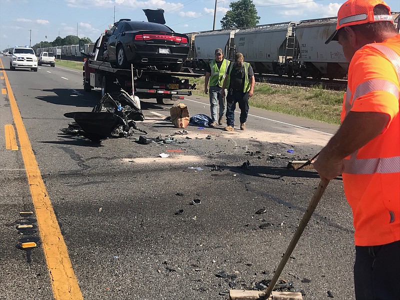 Crews work to clean up debris after a fatal three-vehicle accident Tuesday on U.S. Highway 71 near Ashdown, Ark., in Little River County. The accident happened at 3:04 p.m. in front of Domtar Paper Mill. Traffic remained backed up in the southbound lanes for a couple of hours. (Photo by Tom Morrissey)
