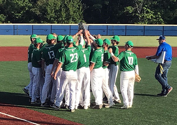 The Blair Oaks Falcons hoist their first-place trophy Tuesday after defeating the California Pintos 12-1 in five innings in the championship game of the Class 3 District 14 Tournament in California.