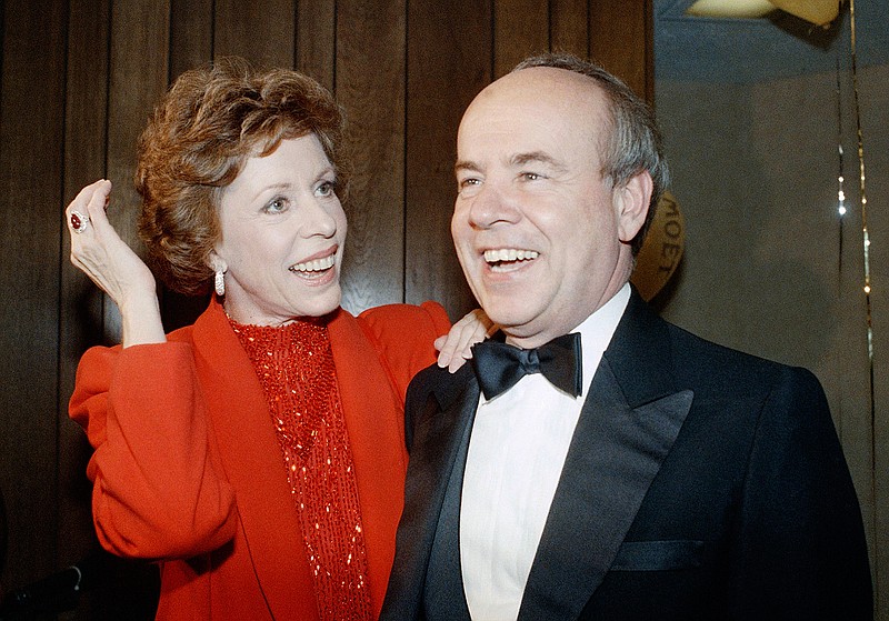 In this April 26, 1986 file photo, Carol Burnett, left, and veteran comrade in comedy Tim Conway laugh during a gala birthday party for Burnett in Los Angeles.  Conway, the impish second banana to Burnett who won four Emmy Awards on her TV variety show, starred aboard "McHale's Navy" and later created a very short character named Dorf, has died. He was 85. Conway died Tuesday morning, May 14, 2019,  in a Los Angeles care facility after a long illness, according to Howard Bragman, who heads LaBrea Media.  (AP Photo/Nick Ut, File)