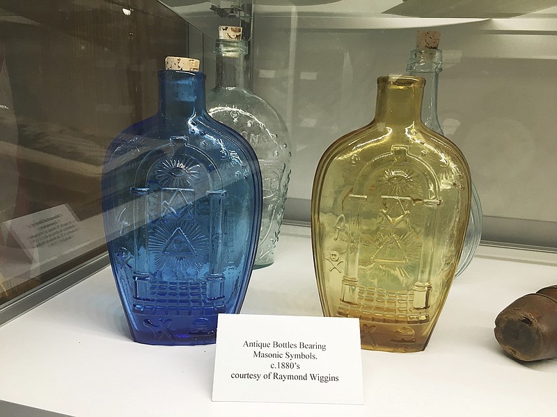 Antique bottles bearing Masonic symbols are among items displayed in the new museum at the Milam Lodge No. 2 in Nacogdoches, Texas.  (Nicole Bradford/The Daily Sentinel via AP)