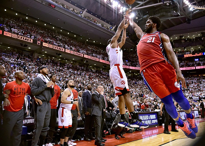 Philadelphia 76ers center Joel Embiid (21) fails to stop Toronto Raptors forward Kawhi Leonard's (2) last-second basket during the second half of an NBA Eastern Conference semifinal basketball game in Toronto on Sunday, May 12, 2019. (Frank Gunn/The Canadian Press via AP)