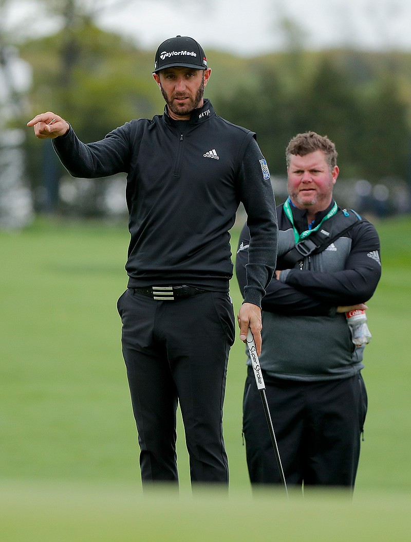 Dustin Johnson checks the break in the green on the 11th hole during a practice round at the PGA Championship golf tournament, Tuesday, May 14, 2019, in Farmingdale, N.Y. (AP Photo/Julie Jacobson)