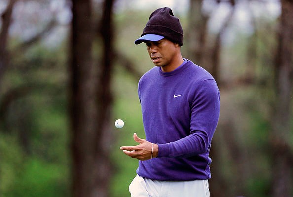 Tiger Woods flips a ball as he walks near the ninth green during a practice round Monday for the PGA Championship in Farmingdale, N.Y.