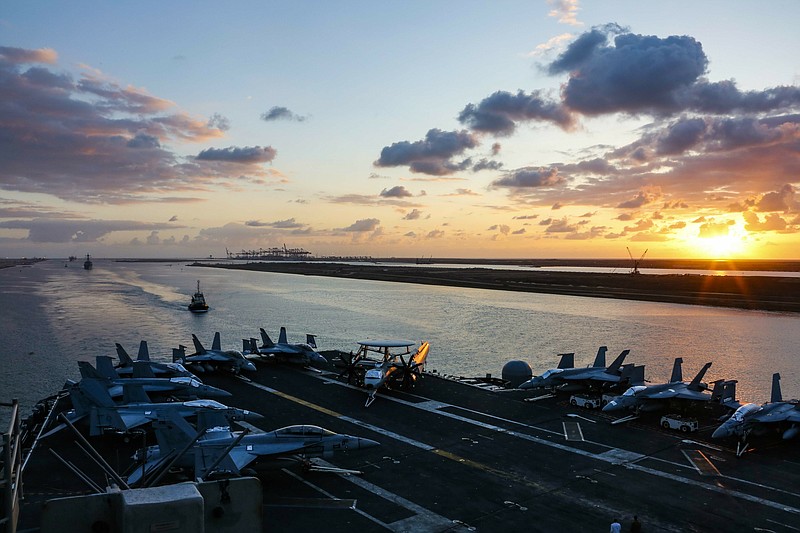 In this Thursday, May 9, 2019 photo released by the U.S. Navy, the Nimitz-class aircraft carrier USS Abraham Lincoln transits the Suez Canal in Egypt. The aircraft carrier and its strike group are deploying to the Persian Gulf on orders from the White House to respond to an unspecified threat from Iran. (Mass Communication Specialist Seaman Dan Snow, U.S. Navy via AP)