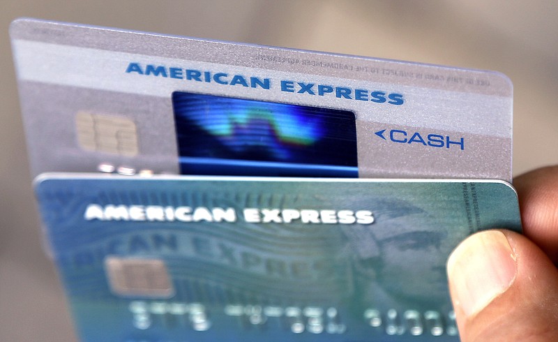 FILE - In this July 18, 2016, file photo, American Express credit cards are photographed in North Andover, Mass. American Express is buying the online reservation startup Resy, the companies announced Wednesday, May 15, 2019, the latest move by AmEx to establish and maintain a foothold for its card members in some of the world's most desired restaurants. (AP Photo/Elise Amendola, File)