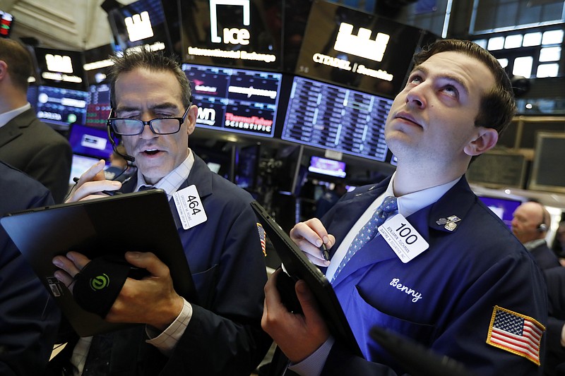 FILE - In this May 9, 2019, file photo traders Gregory Rowe and Benjamin Tuchman work on the floor of the New York Stock Exchange. The U.S. stock market opens at 9:30 a.m. EDT on Wednesday, May 15. (AP Photo/Richard Drew, File)