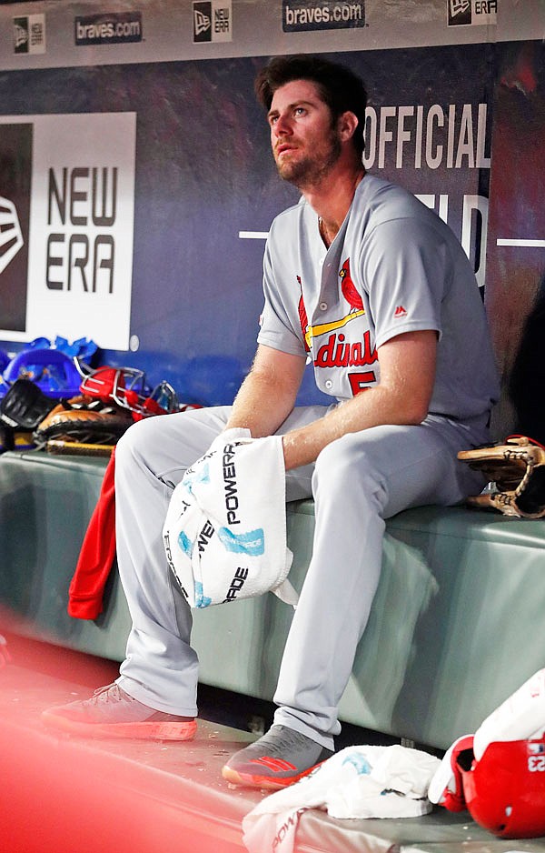 Cardinals relief pitcher John Gant sits on the bench after working in the eighth inning of Wednesday night's game against Braves in Atlanta.