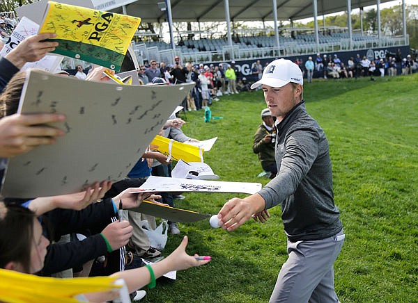 Jordan Spieth signs autographs for fans after finishing a practice round Wednesday for the PGA Championship at Bethpage Black in Farmingdale, N.Y.