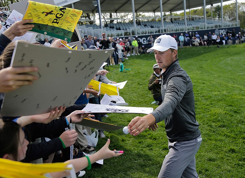 Jordan Spieth signs autographs for fans after finishing a practice round for the PGA Championship golf tournament, Wednesday, May 15, 2019, at Bethpage Black in Farmingdale, N.Y. (AP Photo/Seth Wenig)