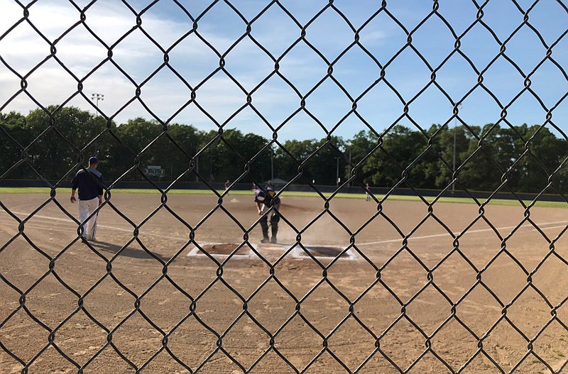 An umpire prepares on May 15, 2019, for St. Elizabeth Hornets to take on Pilot Grove in the Class 1 District 10 Tournament title game. The Hornets defeated the Tigers 11-1.