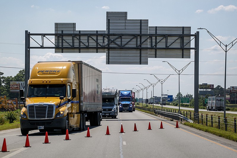 Trucks and cars detour on the Four States Fair Parkway exit because of a vehicle fire at mile marker three of Interstate 30 eastbound on Wednesday in Texarkana, Ark. The vehicle that caught fire forced police to shut down the interstate to the Parkway exit and caused traffic to be backed up at a majority of the I-30 exits and to the bridge of Summerhill  Road.