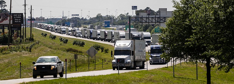 Trucks and cars taking the Four States Fair Parkway exit due to a vehicle  fire at mile marker three of Interstate 30 eastbound on Wednesday in Texarkana, Ark. 
