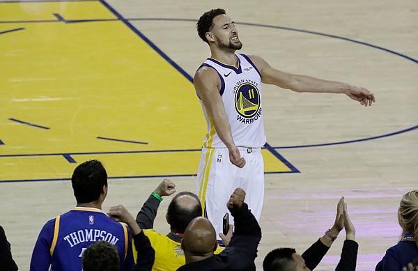 Klay Thompson celebrates with Warriors fans during Tuesday night's game against the Trail Blazers in Oakland, Calif.