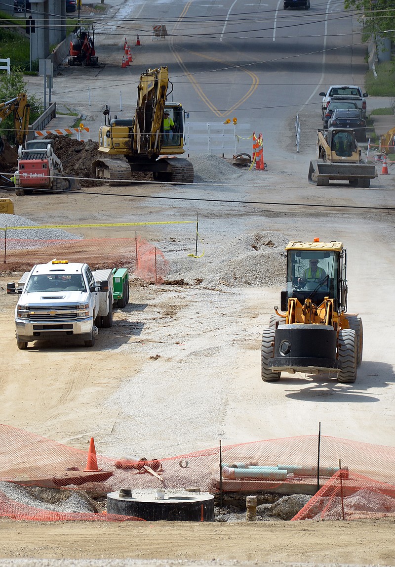 Construction workers from Missouri American Water work near a replaced water main Wednesday on Dunklin Street. As part of the reconstruction project, Missouri American Water is upgrading water infrastructure.