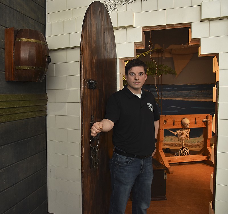 Julie Smith/News Tribune
Dustin Copple, owner of Epoch Escapes, poses for a photograph in Kraken Kove at the new location of the business, which is located in the Capital Mall. There are three themed rooms that give customers a variety of experiences. 