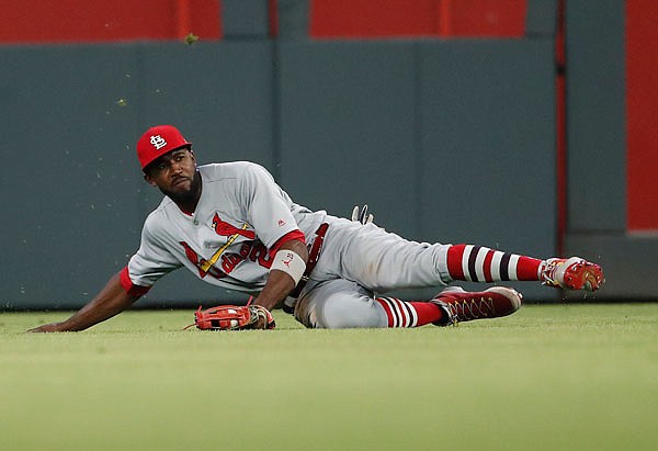 Cardinals outfielder Dexter Fowler makes a sliding catch on a fly ball from the Braves' Josh Donaldson during the eighth inning of Thursday night's game in Atlanta. The Braves won 10-2.