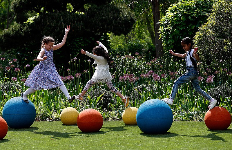 Children enjoy the new Children's Garden at Kew, designed around the elements that plants need to grow, at Kew Gardens in London, Thursday, May 16, 2019. The new garden covers 10,000m, the size of nearly 40 tennis courts and is for youngsters to explore and play in. (AP Photo/Frank Augstein)