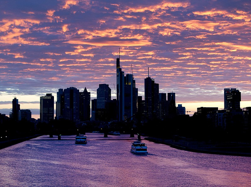 Ships pass by on the river Main after the sun set in Frankfurt, Germany, Wednesday, May 15, 2019. (AP Photo/Michael Probst)