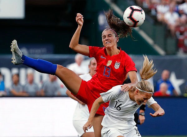 Alex Morgan (13) of the United States and New Zealand's Katie Duncan vie for the ball during the first half of Thursday night's international friendly soccer match at Busch Stadium.