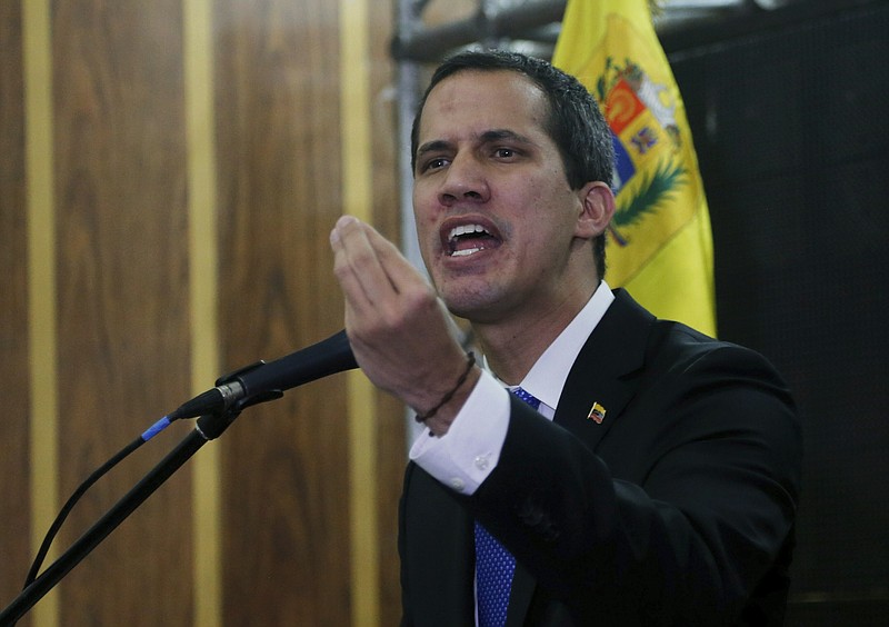 Venezuela's opposition leader and self-proclaimed interim president Juan Guaid speaks during a meeting with the  Chamber of Commerce, in Caracas, Venezuela, Thursday, May 16, 2019. Guaid referred to the Norwegian initiative, efforts to mediate between the opposition and the government of President Nicols Maduro, in remarks on Thursday, but said the opposition won't enter into any "false negotiation." (AP Photo/Fernando Llano)