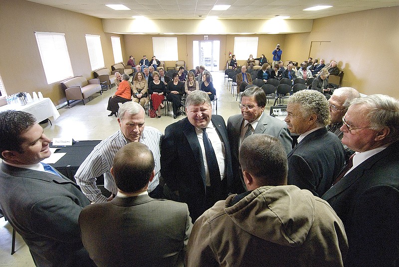 Mike Brock, legal counsel for New Boston, Hooks and Wake Village, center, is surrounded by the Riverbend Water District mayors before they sign resolutions ending a nine-year lawsuit in this 2010 file photo. 