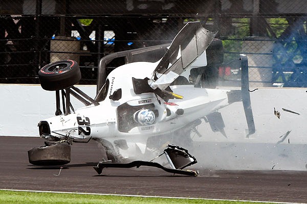 The car driven by Kyle Kaiser turns on its side after hitting the wall along the third turn during practice Friday for the Indianapolis 500 at Indianapolis Motor Speedway in Indianapolis.