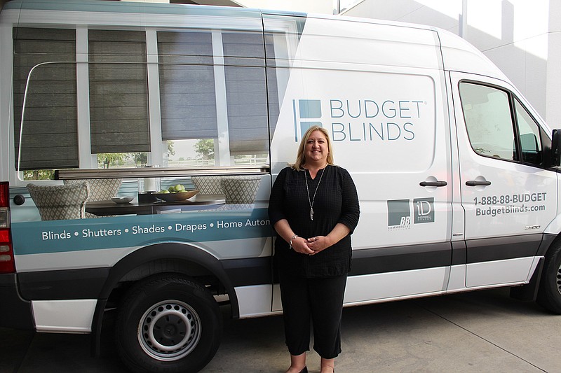 Kellianne Turner, owner of Budget Blinds Texarkana, poses for a portrait next to her van at the store in Texarkana, Texas. (Submitted photo)
