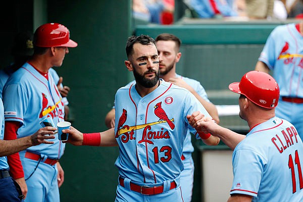 Matt Carpenter is congratulated in the Cardinals dugout in the second inning of Saturday's' game against the Rangers in Arlington, Texas.