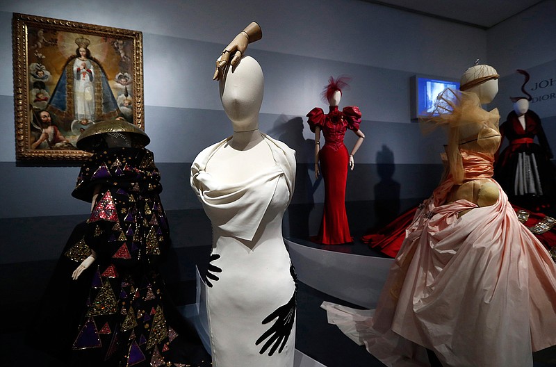 In this May 14, 2019 photo, Christian Dior dresses are shown that are part of the exhibit, "Dior, From Paris To The World", at The Dallas Museum of Art in Dallas. The more than 70 years of fashion created by the famed House of Dior will be examined in an exhibit opening in Dallas that will feature almost 200 dresses. (AP Photo/Tony Gutierrez)