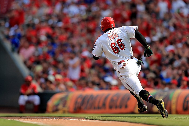 Cincinnati Reds' Yasiel Puig runs the bases as he hits a two-run RBI single in the third inning of a baseball game against the Los Angeles Dodgers, Saturday, May 18, 2019, in Cincinnati. (AP Photo/Aaron Doster)