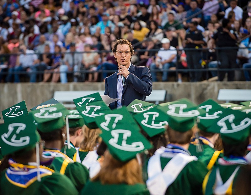 Actor and 1988 Longview High School graduate Matthew McConaughey delivers the commencement speech at the school's graduation ceremony in Longview, Texas, on Friday, May 17, 2019. McConaughey has finally received his high school diploma, more than 30 years after graduating. (Les Hassell/The News-Journal via AP)