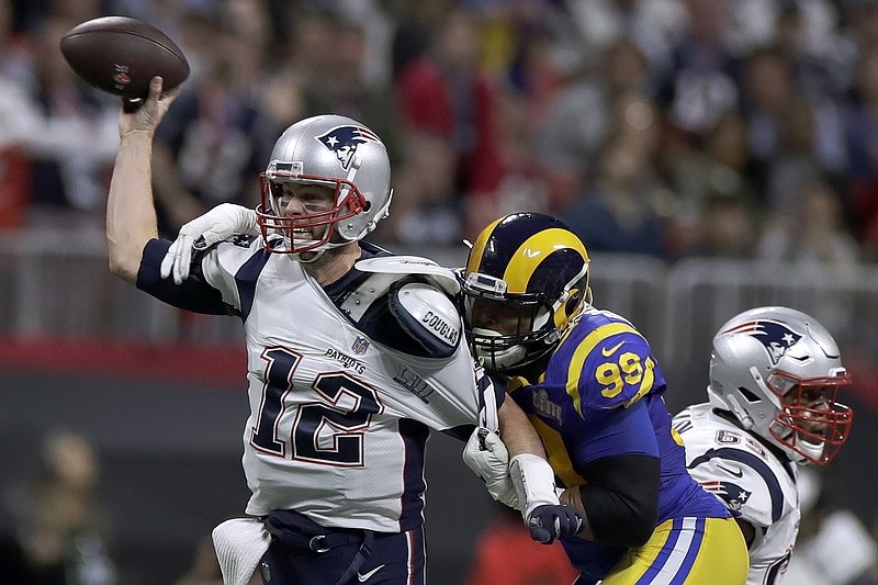 This Feb. 3, 2019 file photo shows New England Patriots' Tom Brady (12) passing under pressure form Los Angeles Rams' Aaron Donald (99) during the first half of the NFL Super Bowl 53 football game in Atlanta. Brady will soon slip on his sixth Super Bowl ring, and Herb Adderley is the only other man on the planet who can relate to that level of success as the National Football League celebrates its 100th season.
"It's going to be a long time, another 100 years, before somebody wins himself six titles," said Adderley, the Hall of Fame cornerback for Vince Lombardi's great Green Bay Packers teams of the 1960s. (AP Photo/Carolyn Kaster, File)
