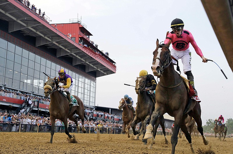 Jockey Tyler Gaffalione, right, reacts aboard War of Will, as they crosses the finish line first to win the Preakness Stakes horse race at Pimlico Race Course, Saturday, May 18, 2019, in Baltimore.(AP Photo/Steve Helber)