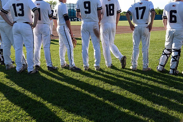 The Helias baseball team stands on the field to support the team's seniors on Senior Day this season at the American Legion Post 5 Sports Complex. Helias is one of seven schools starting the Central Missouri Activities Conference in the 2020-21 school year.