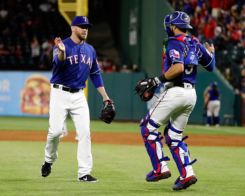 Texas Rangers relief pitcher Shawn Kelley, left, and catcher Isiah Kiner-Falefa, right, celebrate the team's 8-5 win in a baseball game against the Toronto Blue Jays in Arlington, Texas, Saturday, May 4, 2019. (AP Photo/Tony Gutierrez)