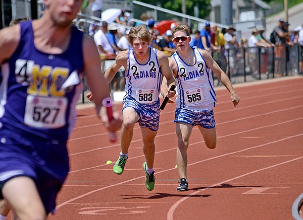 Russellville's Collin Lueckenotte hands passes the baton to Ethan Huff during Friday's preliminary race of the boys 4x200-meter relay at the Class 1 state track and field championships at Adkins Stadium. Russellville advanced to the final and finished in eighth place Saturday.