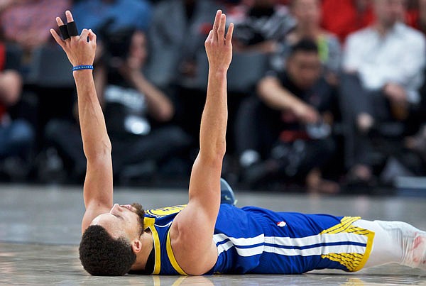 Warriors guard Stephen Curry reacts after being fouled and making a 3-point basket Saturday against the Trail Blazers during the second half of Game 3 of the Western Conference final in Portland, Ore. The Warriors won 110-99. 