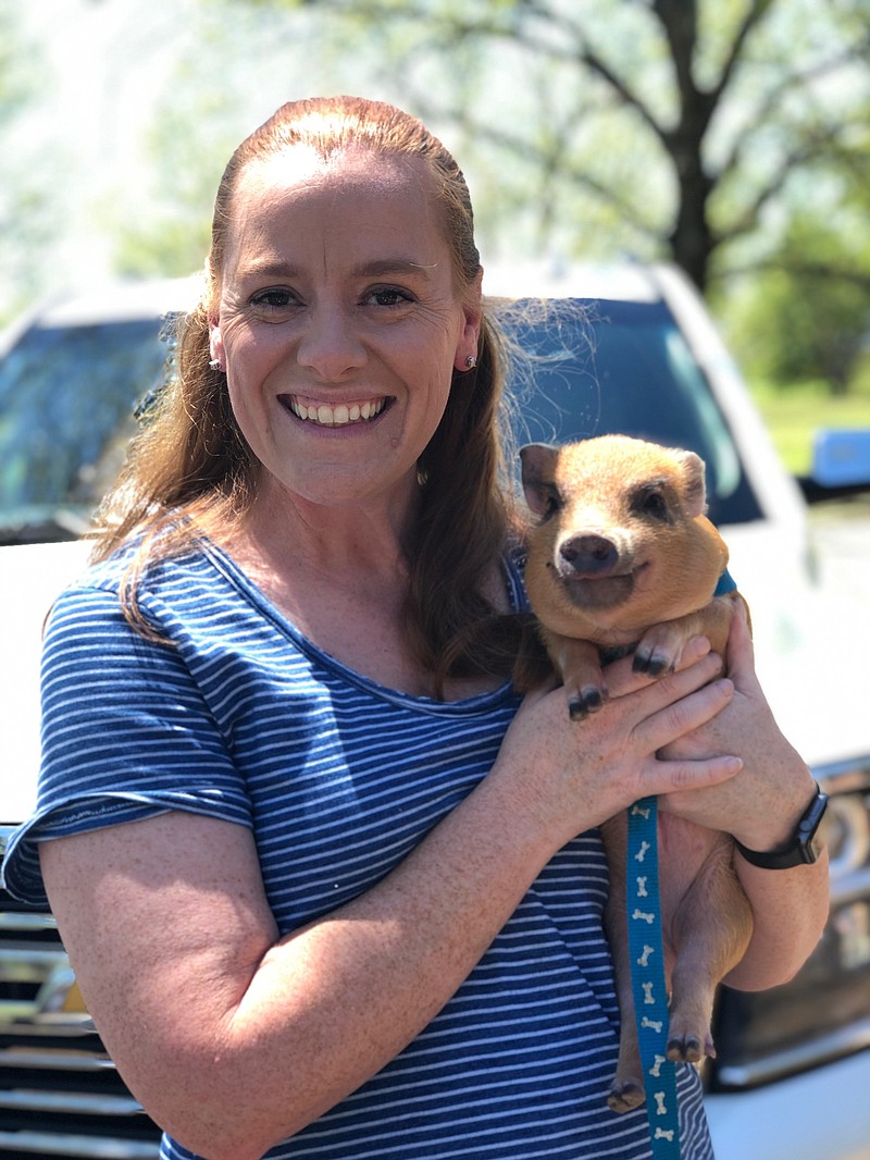 Mary Beth Gunter, a wildlife programmer with Animalogy, poses for a photo with a pig named Poppy. Animalogy, wildlife education experts who give children an opportunity to interact with animals, will be part of the Texarkana Public Library Summer Reading Club's invitation-only reward party July 19.
