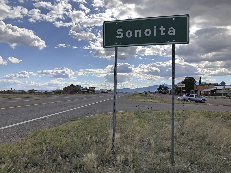 In this photo taken Monday, May 13, 2019, a sign for Sonoita stands in the heart of southeastern Arizona where owners of wineries and other small tourism operations worry that the Rosemont Copper Mine proposed to be built in the nearby Santa Rita Mountains could harm their businesses with mining trucks rumbling down scenic state highway 83 that runs past the range. Native American tribes are seeking an injunction to halt work on the copper mine project they say will desecrate burial and other sacred sites in the Santa Rita Mountains of southeastern Arizona. (AP Photo/Anita Snow)