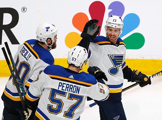 Ryan O'Reilly (left) and David Perron (57) celebrate with Blues teammate Jaden Schwartz after he scored a goal in the third period of Sunday afternoon's game against the Sharks in San Jose, Calif.