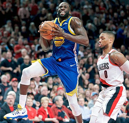 Draymond Green of the Warriors drives to the basket during Saturday night's game against the Trail Blazers in Portland, Ore.