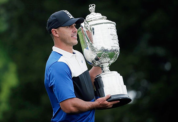 Brooks Koepka holds the Wanamaker Trophy after winning the PGA Championship on Sunday at Bethpage Black in Farmingdale, N.Y.